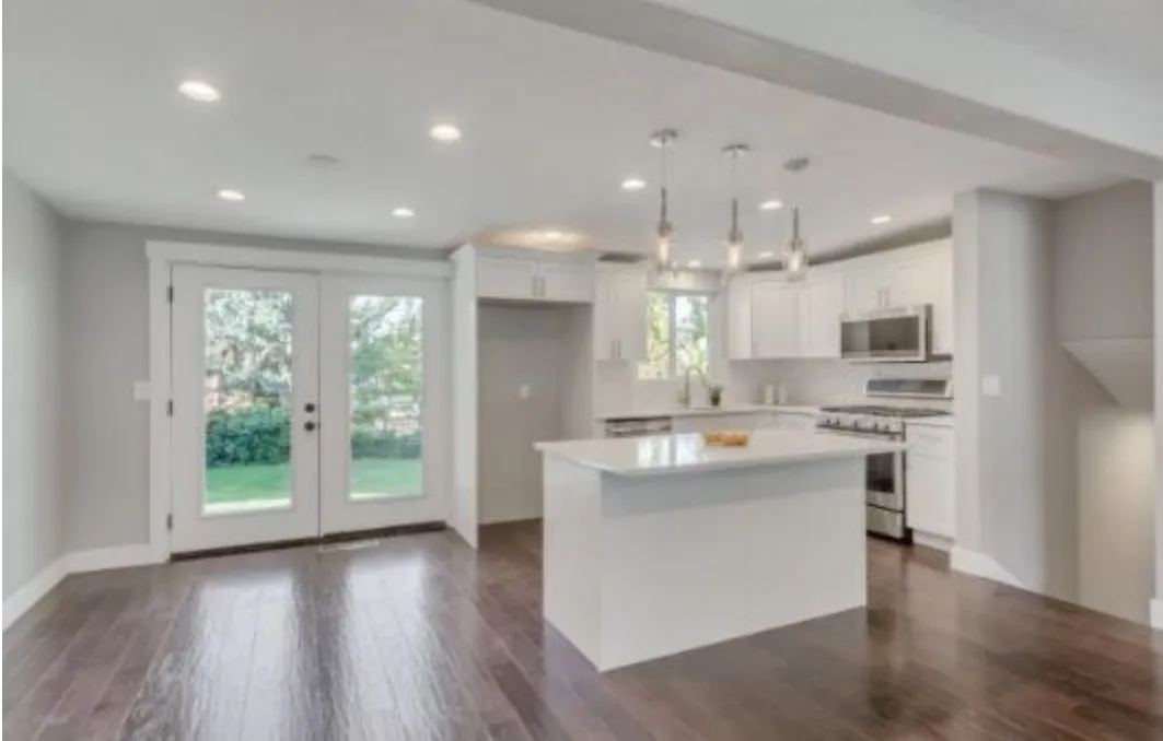 White shaker kitchen with island and pendant lights