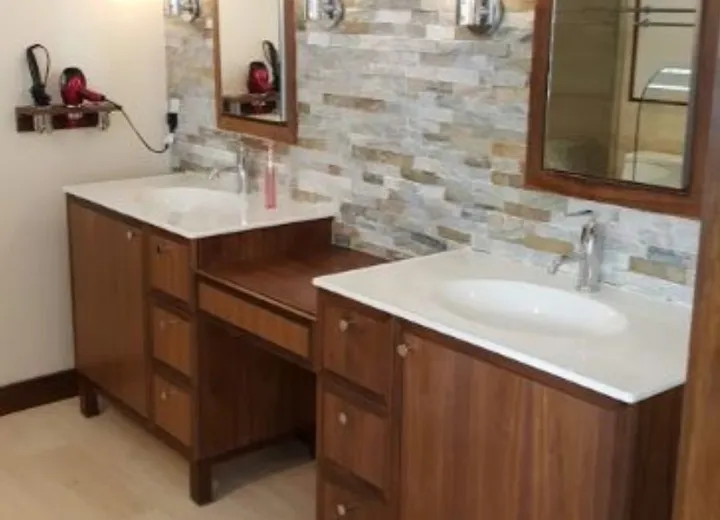 Double vanity with stacked stone backsplash and new plumbing